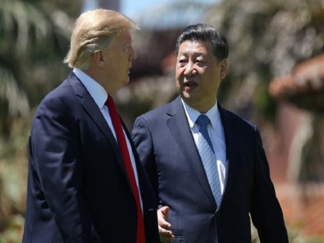 U.S. President Donald Trump and China's President Xi Jinping chat as they walk along the front patio of the Mar-a-Lago estate after a bilateral meeting in Palm Beach